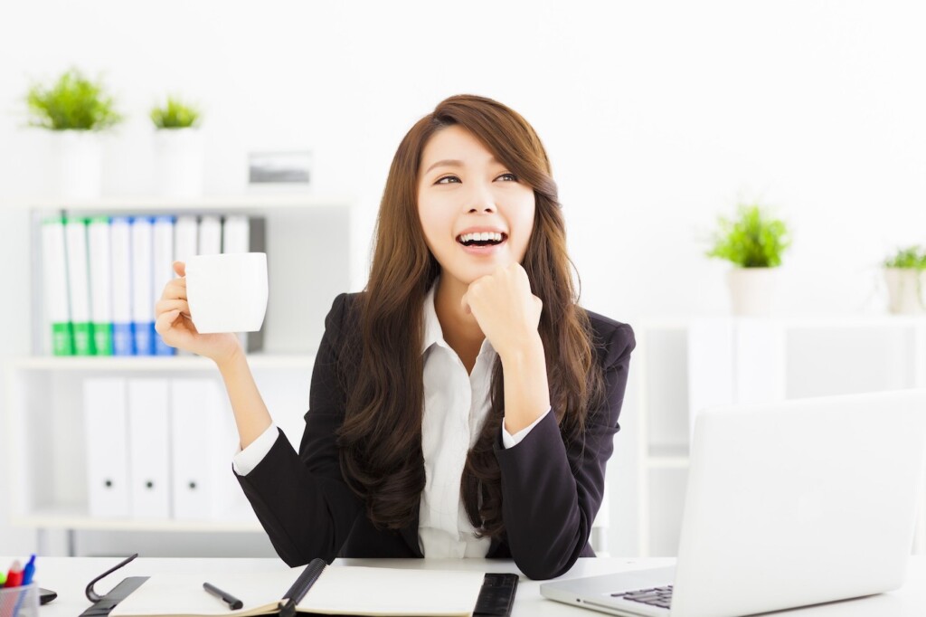 beautiful young business woman drinking coffee in office